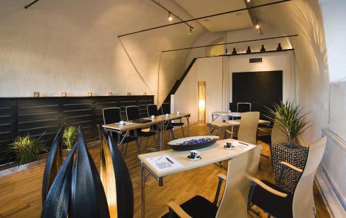 a restaurant with tables and chairs and a chalkboard at Ulfsunda Slott in Stockholm
