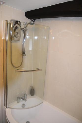a bathroom with a shower and a sink at Sweetbriar Cottage Bed & Breakfast and Camping in Starbotton