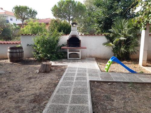 a backyard with a grill and a playground at Apartments Kana in Pula