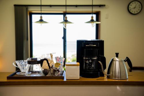 a kitchen counter with a coffeemaker and a coffee maker at 山里の家 in Nanjo