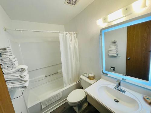 a bathroom with a sink and a toilet and a mirror at Americas Choice Inn & Suites in Gila Bend