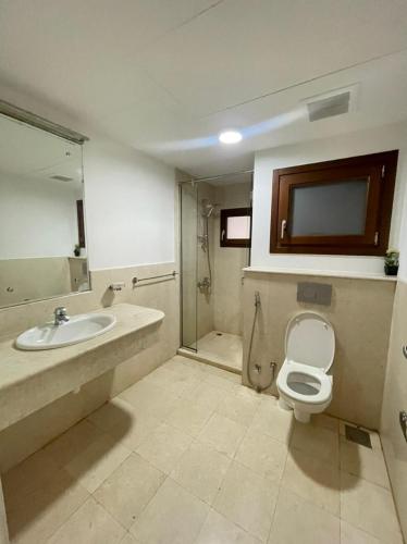 a bathroom with a toilet and a sink and a shower at Hawana apartment in Salalah