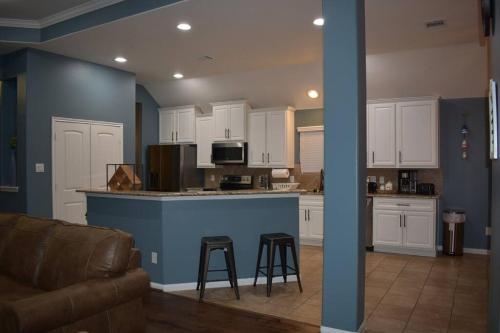 a kitchen with white cabinets and a blue counter top at Spacious Conroe Home around 4 miles to the Lake in Montgomery