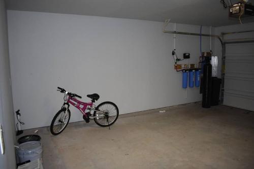 a bike parked against a wall in a garage at Spacious Conroe Home around 4 miles to the Lake in Montgomery