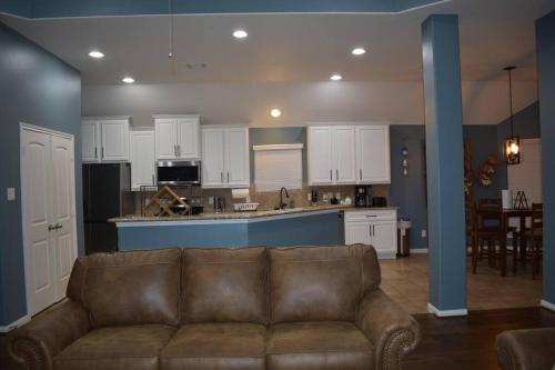 a living room with a couch and a kitchen at Spacious Conroe Home around 4 miles to the Lake in Montgomery
