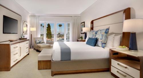 a bedroom with a large bed and a television at Balboa Bay Resort in Newport Beach