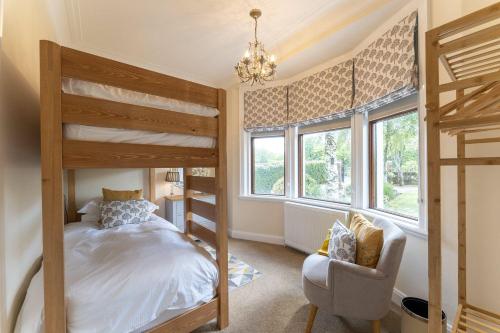 a bedroom with two bunk beds and a chair at St Michael's in Kippen