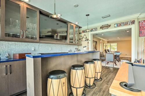 a restaurant with a bar with stools at Luxe Cape Coral Escape with Pool 4 Mi to Beach in Cape Coral