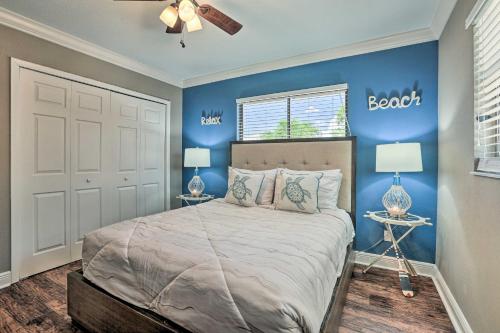 a bedroom with blue walls and a bed with two lamps at Luxe Cape Coral Escape with Pool 4 Mi to Beach in Cape Coral