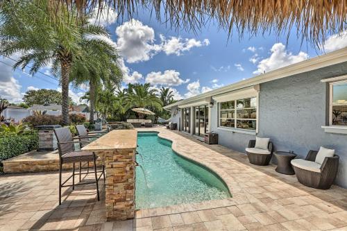a swimming pool with a table and chairs next to a house at Luxe Cape Coral Escape with Pool 4 Mi to Beach in Cape Coral