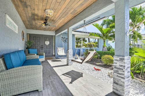 a living room with a couch and a swing at Luxe Cape Coral Escape with Pool 4 Mi to Beach in Cape Coral