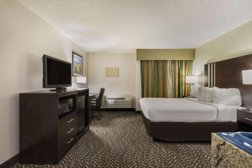 a hotel room with a bed and a flat screen tv at Best Western Indian Oak in Chesterton