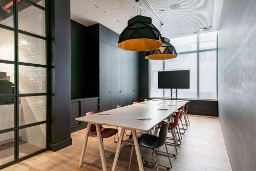 a conference room with a long table and chairs at Radisson RED Brussels in Brussels