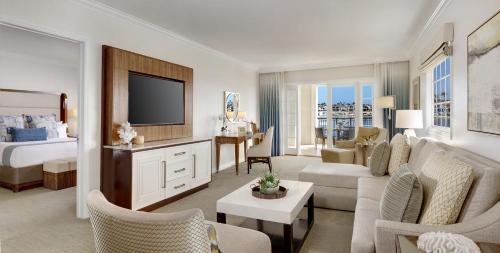 a hotel room with a bed and a living room at Balboa Bay Resort in Newport Beach