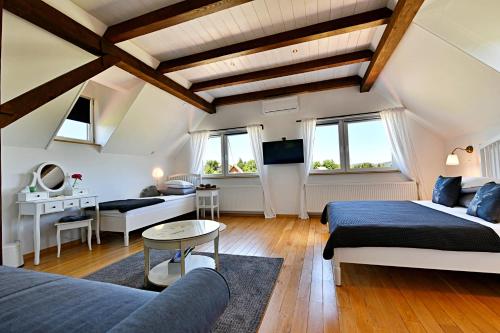 a bedroom with two beds and a living room at MY WAY apartman i sobe in Saborsko