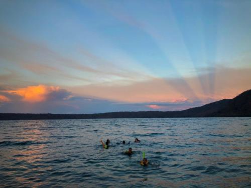 a group of people in the water at sunset at Casa Única in La Laguna