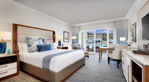 a hotel room with a large bed and a desk at Balboa Bay Resort in Newport Beach