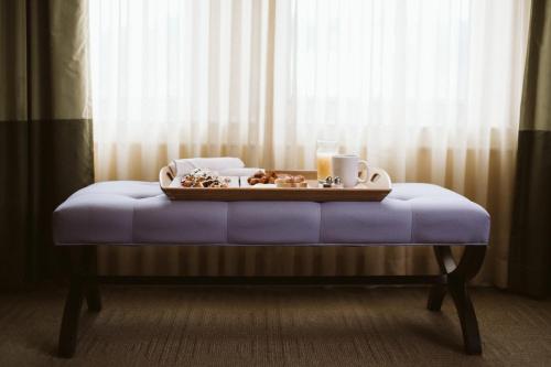 a tray of food on a bed in a room at Hotel DeLuxe in Portland