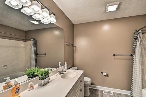 a bathroom with a sink and a toilet and a mirror at 1 Mi to Cape Fear River Pet-Friendly Retreat in Lillington