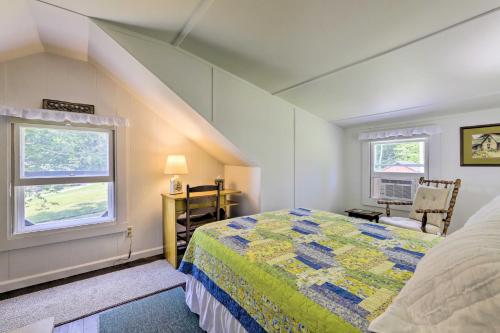 a attic bedroom with a bed and a window at Lakefront Cottage with Covered Porch and Dock! in Coventry