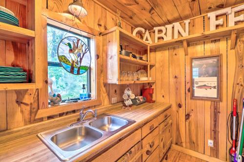 a kitchen with a sink and a window in a cabin at Mountian View Retreat Less Than 2 Mi to White River! in Mountain View