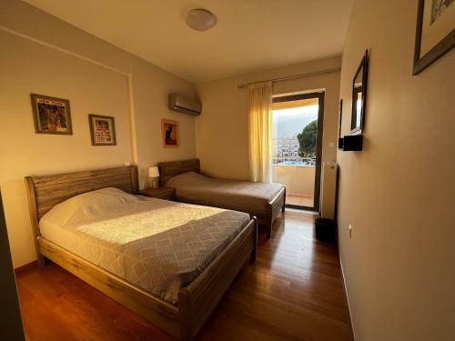 a small bedroom with a bed and a window at The Spartan Penthouse in Sparti