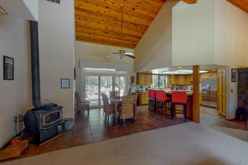 a kitchen and living room with a stove and a table at Yosemite Nutter Ranch in Mariposa