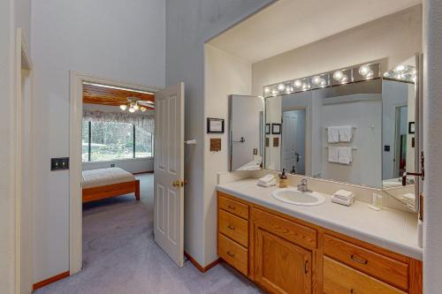 a bathroom with a sink and a large mirror at Yosemite Nutter Ranch in Mariposa