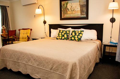 a hotel room with a bed with two pillows at The Whitetail Inn and Suites- Lincoln in Lincoln
