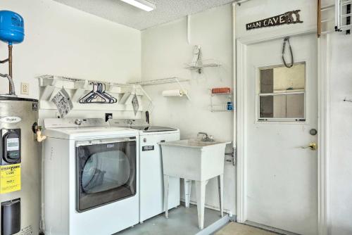 a kitchen with a washing machine and a sink at Pet-Friendly Port St Lucie Home - 7 Mi to Beaches! in North River Shores