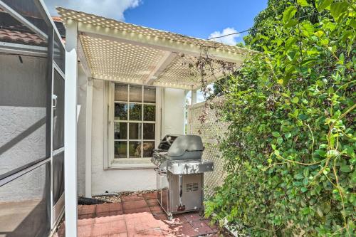 a patio with a grill in front of a house at Pet-Friendly Port St Lucie Home - 7 Mi to Beaches! in North River Shores