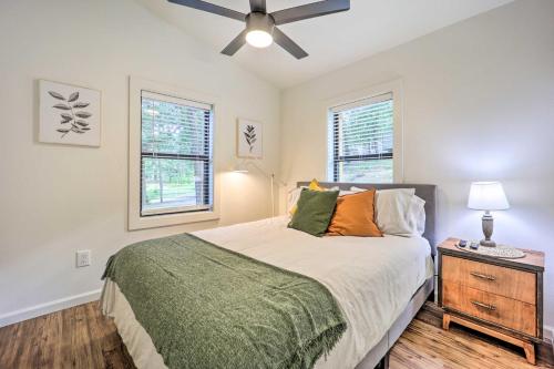a bedroom with a bed and a ceiling fan at Updated Lakefront Cabin with Deck and Boat Dock! in Eucha