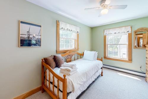 a bedroom with a bed and two windows at The Wheelhouse in Camden