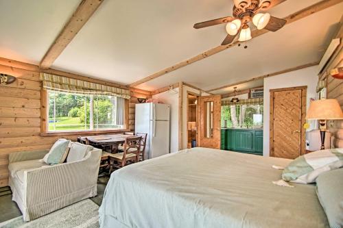 a bedroom with a large bed and a table at Peaceful Horicon Studio with Rock River Access! in Juneau