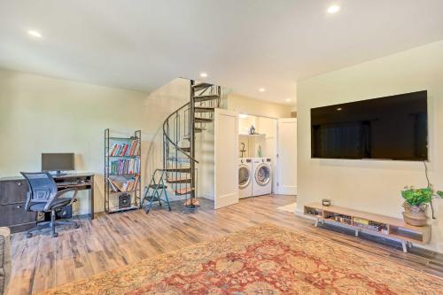 a living room with a flat screen tv and a staircase at Sun-Lit Vernon Condo Less Than 2 Mi to Ski Resort! in Vernon Township
