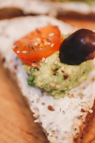 a piece of bread with a tomato on it at LG Golden Suites in San Miguel de Tucumán