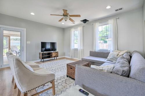 a living room with a couch and a tv at Idyllic Pasadena Retreat with Garden and Hot Tub! in Glen Burnie