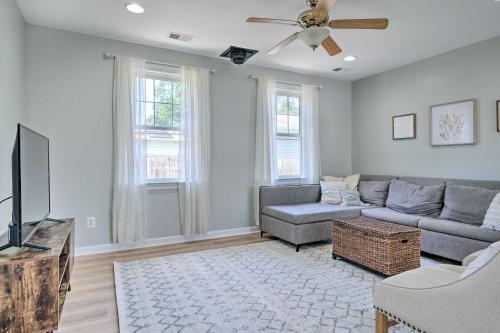a living room with a couch and a tv at Idyllic Pasadena Retreat with Garden and Hot Tub! in Glen Burnie