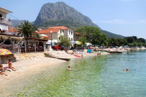 a group of people in the water at a beach at Apartment Zaostrog 6659a in Zaostrog