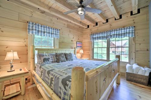 a bedroom with a bed in a log cabin at Luxe Log Cabin with Modern Finishes and Mtn Views in Maggie Valley