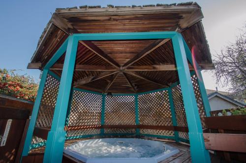 a wooden gazebo with a pool of water at Continental Inn in Santa Cruz