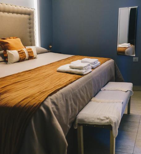 a bedroom with a bed with towels on it at LG Golden Suites in San Miguel de Tucumán