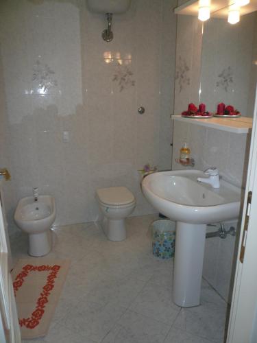 a bathroom with a sink and a toilet and a sink at Alloggio privato Giunic in Cagliari