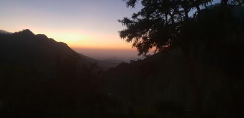 a view of the sun setting on a mountain at Leisure Dream Inn in Ella