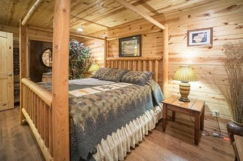 a bedroom with a bed in a log cabin at Nacoochee valley motel in Clarkesville