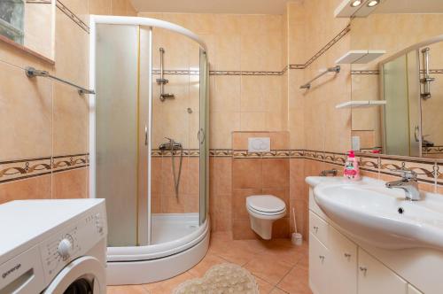 ein Badezimmer mit Dusche, Toilette und Waschbecken in der Unterkunft Apartments by the sea Podgora, Makarska - 11469 in Podgora