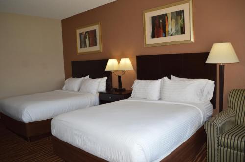 a hotel room with two beds and a chair at First Choice Inn at the Swell in Green River