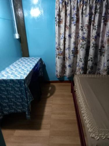 a room with a bed and a window with curtains at Ren-Hana Kundasang in Kundasang