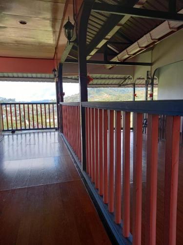 an empty room with a wooden floor and red railing at Ren-Hana Kundasang in Kundasang