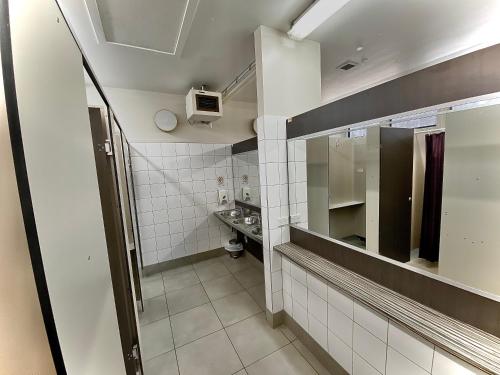 a small bathroom with a sink and a mirror at Hanmer Springs Forest Camp Trust in Hanmer Springs